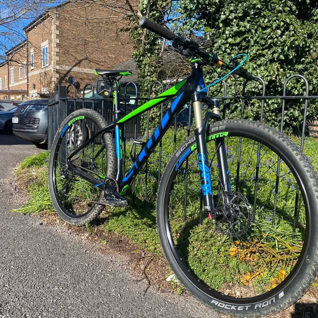 Green and blue hardtail mountain bike after a brake and gear service