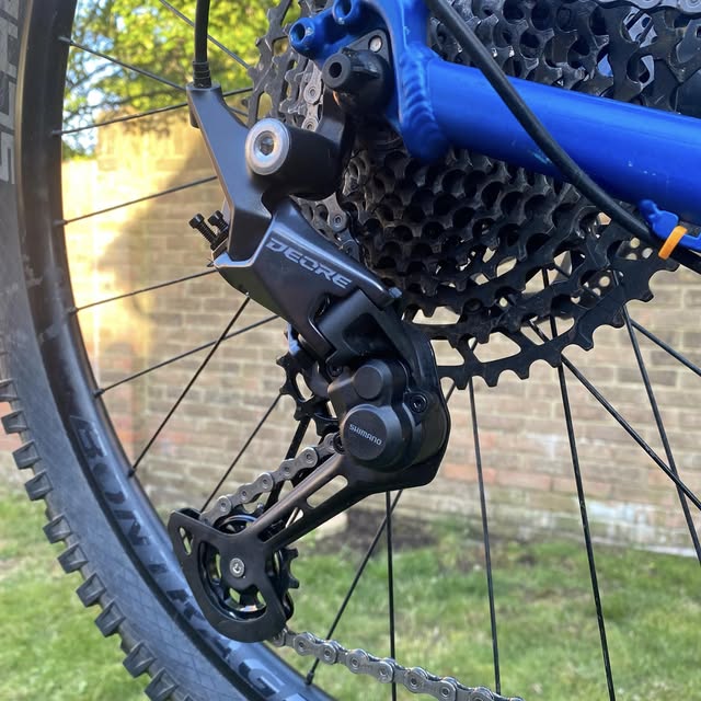 Close-up of a rebuilt Shimano Deore rear derailleur and cassette, cleaned and re-indexed by JJW